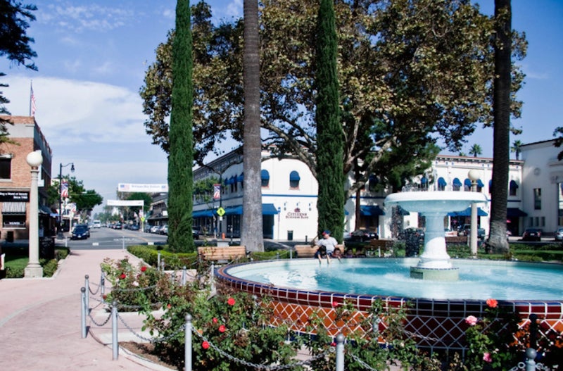 Two children playing in Old Town Orange fountain